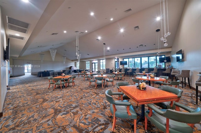 dining room with high vaulted ceiling and carpet floors