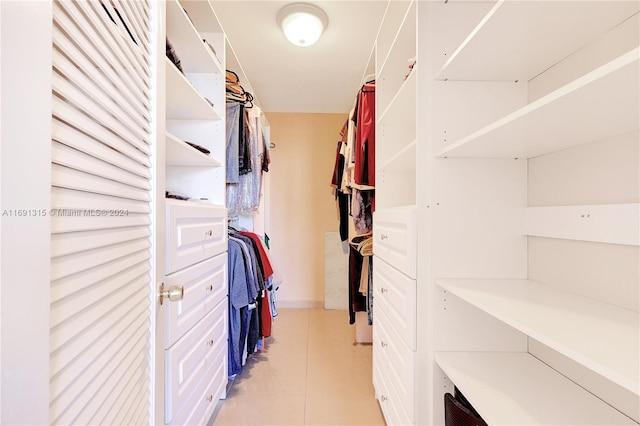 walk in closet with light tile patterned flooring