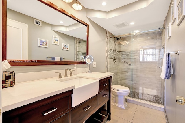 bathroom with walk in shower, vanity, toilet, and tile patterned floors