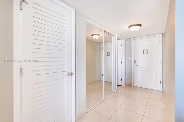 hall featuring light tile patterned floors