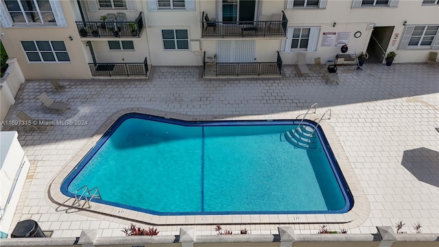 view of swimming pool with a patio area