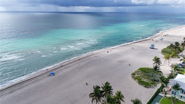 birds eye view of property with a beach view and a water view