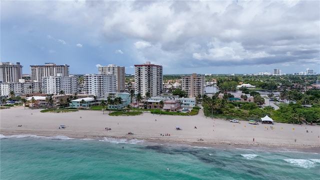 bird's eye view with a water view and a beach view