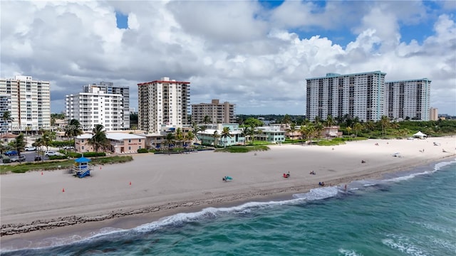 birds eye view of property with a beach view and a water view