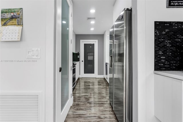 hallway with hardwood / wood-style floors