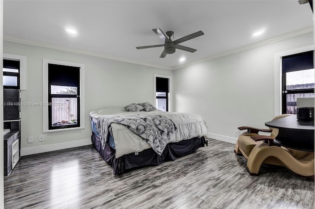 bedroom featuring ornamental molding, hardwood / wood-style floors, and ceiling fan