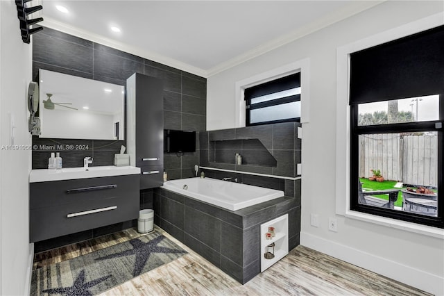 bathroom featuring hardwood / wood-style flooring, ceiling fan, plenty of natural light, and ornamental molding