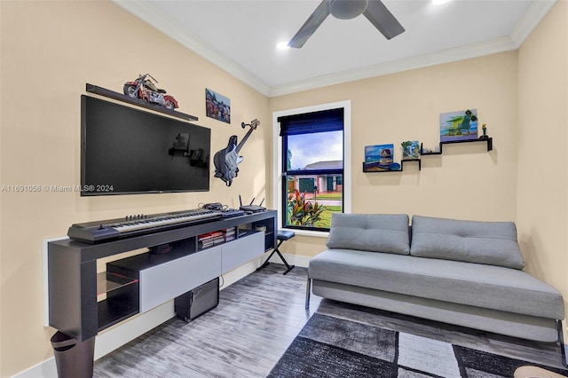 living room with wood-type flooring, ceiling fan, and crown molding