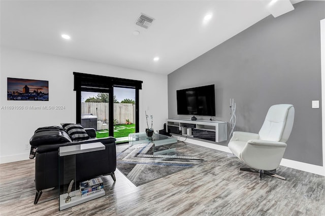 living room with lofted ceiling and hardwood / wood-style flooring