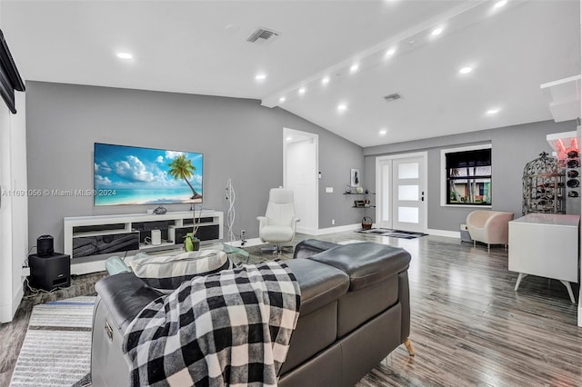 living room featuring vaulted ceiling and wood-type flooring