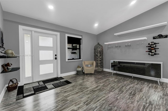 foyer entrance with vaulted ceiling and wood-type flooring