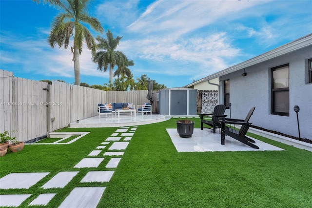 view of yard with a storage unit, a patio, and an outdoor hangout area