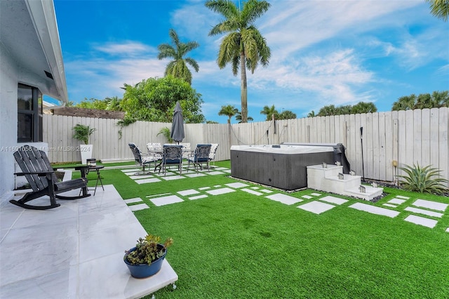 view of yard with a hot tub and a patio area