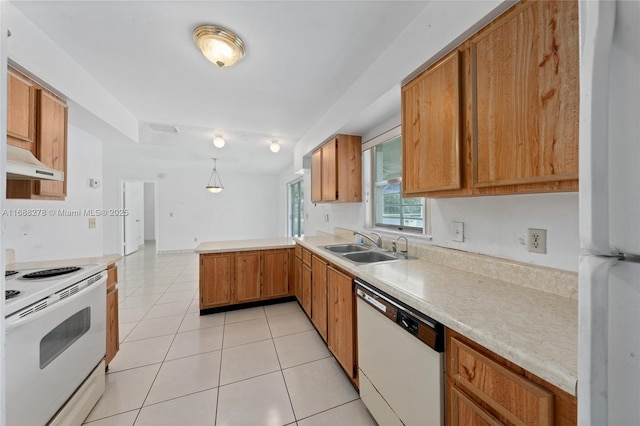 kitchen featuring light tile patterned flooring, sink, hanging light fixtures, kitchen peninsula, and white appliances