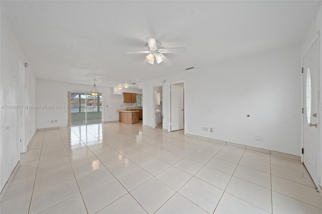 tiled spare room with ceiling fan