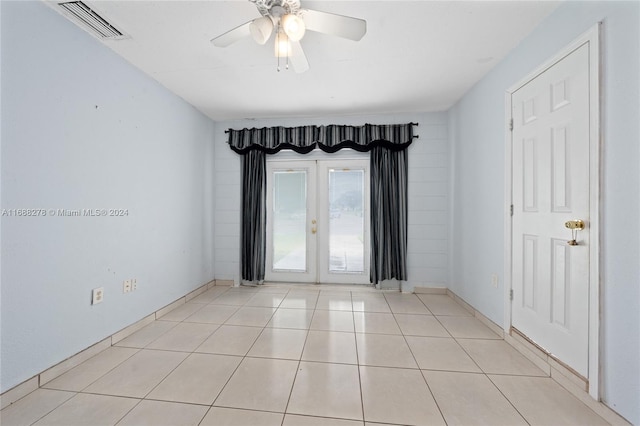 spare room with ceiling fan and light tile patterned floors