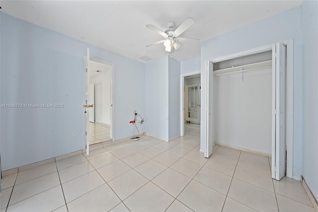 unfurnished bedroom featuring a closet, ceiling fan, and light tile patterned flooring