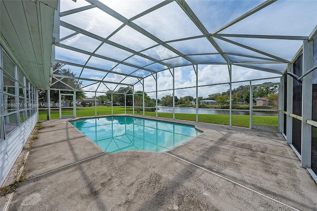 view of swimming pool with a water view, glass enclosure, a yard, and a patio area