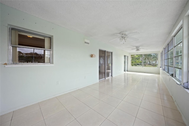 interior space with ceiling fan and a textured ceiling