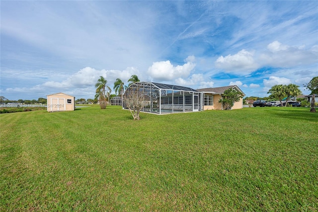 view of yard featuring a lanai and a storage unit