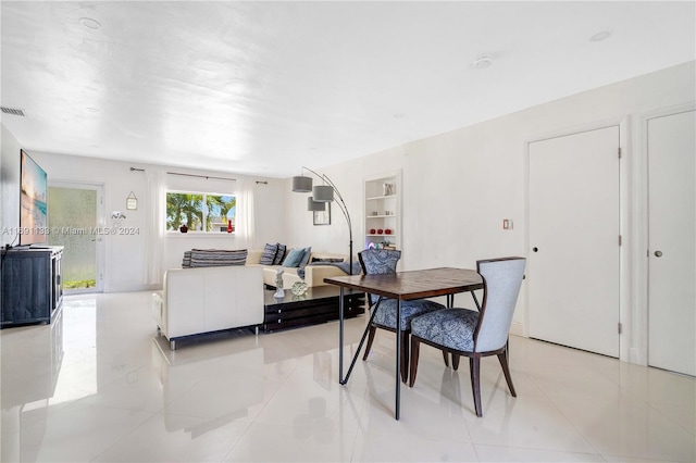 dining area with light tile patterned flooring