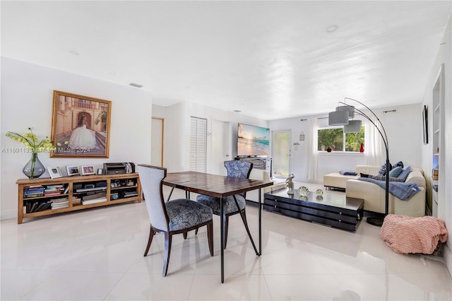 dining area with light tile patterned floors