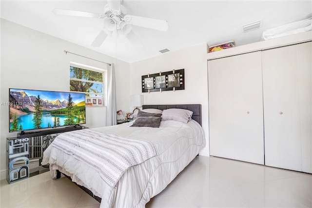 bedroom featuring a closet, ceiling fan, and light tile patterned floors