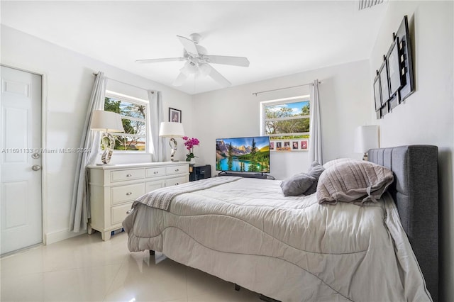 tiled bedroom featuring ceiling fan