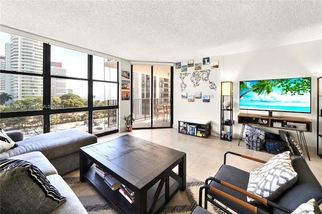 living room with expansive windows, a textured ceiling, and light tile patterned floors