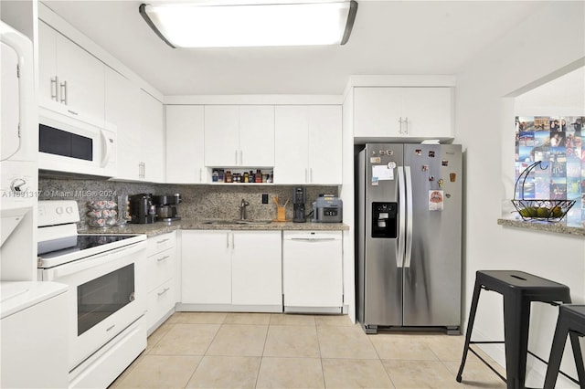 kitchen featuring white cabinets, sink, and white appliances