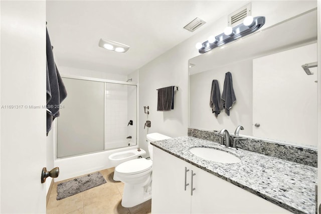 full bathroom with a bidet, toilet, bath / shower combo with glass door, tile patterned flooring, and vanity