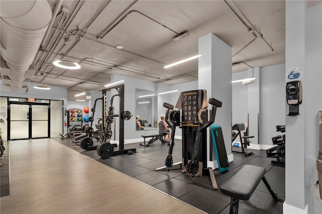 gym with dark hardwood / wood-style flooring