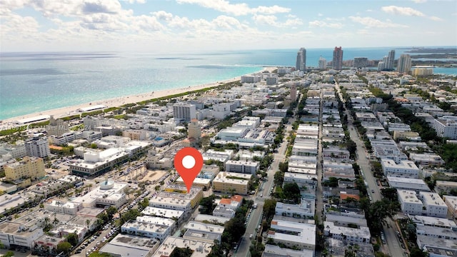 birds eye view of property featuring a view of the beach and a water view