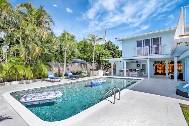 view of swimming pool with ceiling fan and a patio area