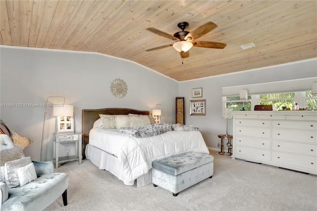 carpeted bedroom with vaulted ceiling, ceiling fan, ornamental molding, and wood ceiling