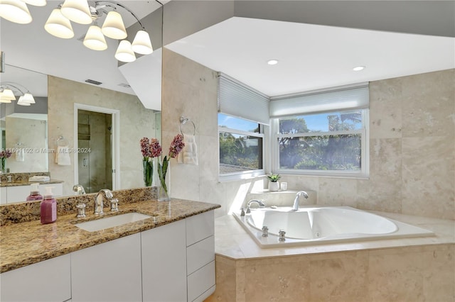 bathroom with vanity, tile walls, and plus walk in shower