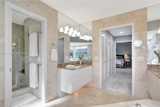 bathroom with tile patterned floors, vanity, and an enclosed shower