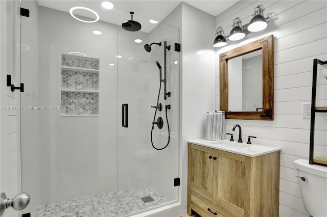 bathroom with vanity, a shower with shower door, and toilet