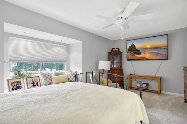 bedroom with ceiling fan and light carpet