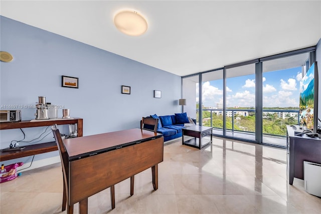 dining space featuring floor to ceiling windows