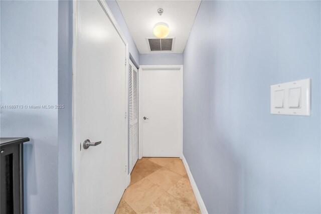 laundry room with stacked washer and dryer