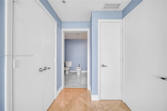 hallway featuring light tile patterned flooring