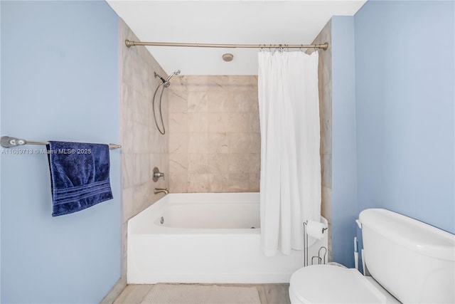 bathroom with shower / tub combo with curtain and toilet