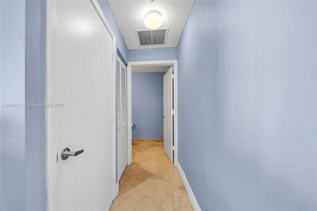 hall featuring light tile patterned flooring