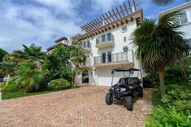 mediterranean / spanish home with a garage and a balcony