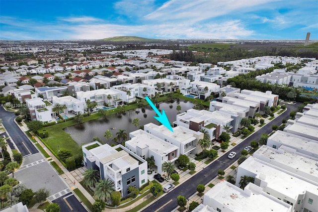 drone / aerial view featuring a residential view and a water view