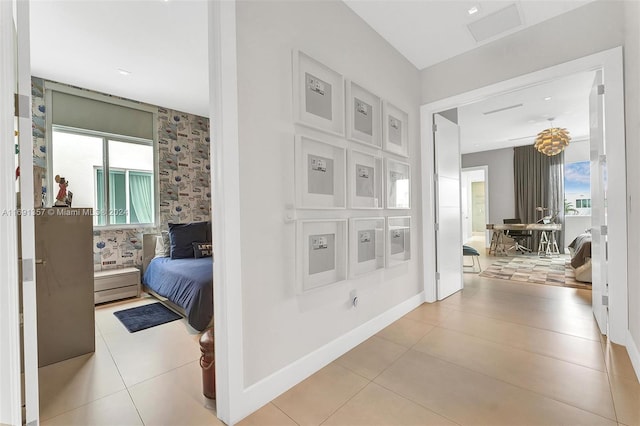 hall with a wealth of natural light and light tile patterned floors