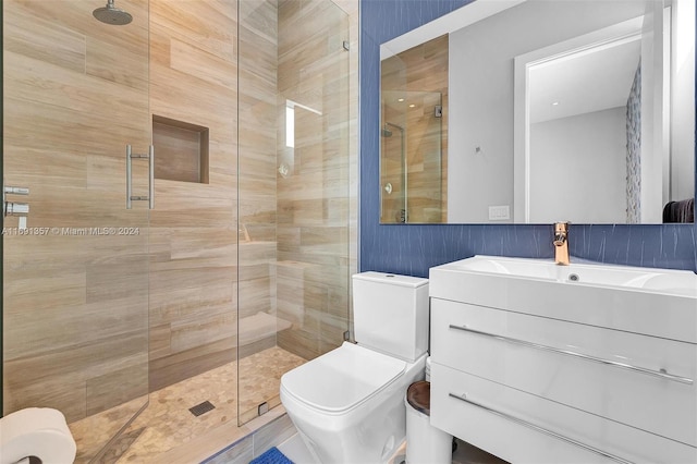 bathroom featuring walk in shower, vanity, toilet, and tile patterned flooring