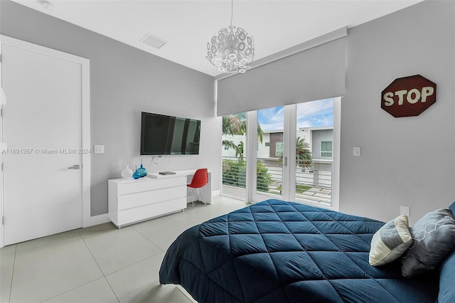 bedroom with an inviting chandelier and light tile patterned flooring