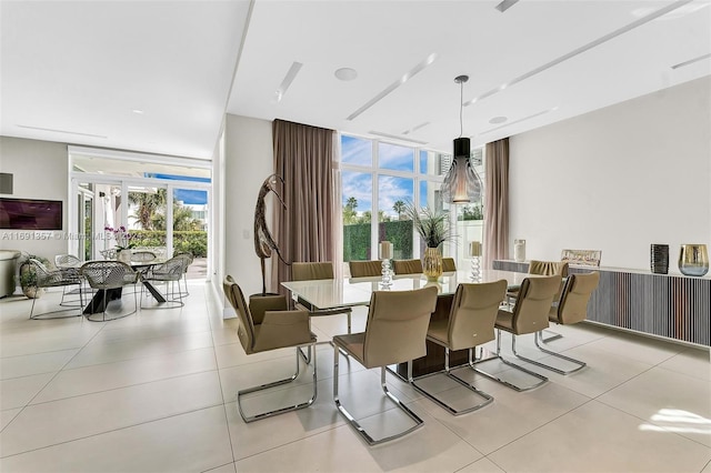 dining room featuring expansive windows, light tile patterned flooring, and plenty of natural light